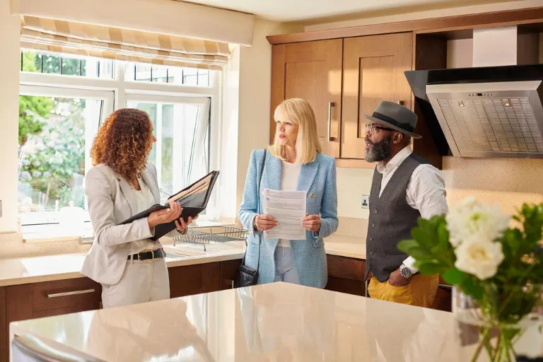 Luxury real estate advisor reviewing legal documents for a resale luxury property with home buyers